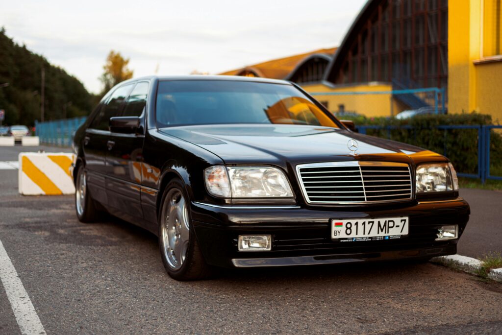 Elegantly parked black luxury sedan with a license plate in Minsk, creating a sleek automotive scene.