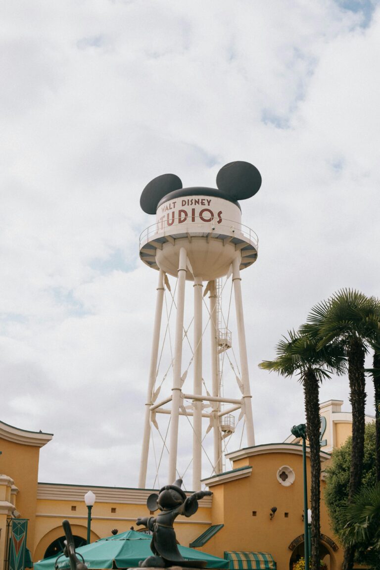 Iconic Mickey Mouse water tower against a cloudy sky in Disneyland Paris.
